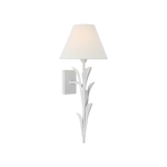 A white wall sconce with a sculptural leaf-like metal frame and a tapered white fabric shade, shown lit against a plain white background.