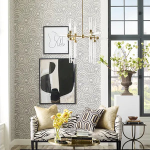 Modern living room with patterned wallpaper, abstract art, and decorative elements.