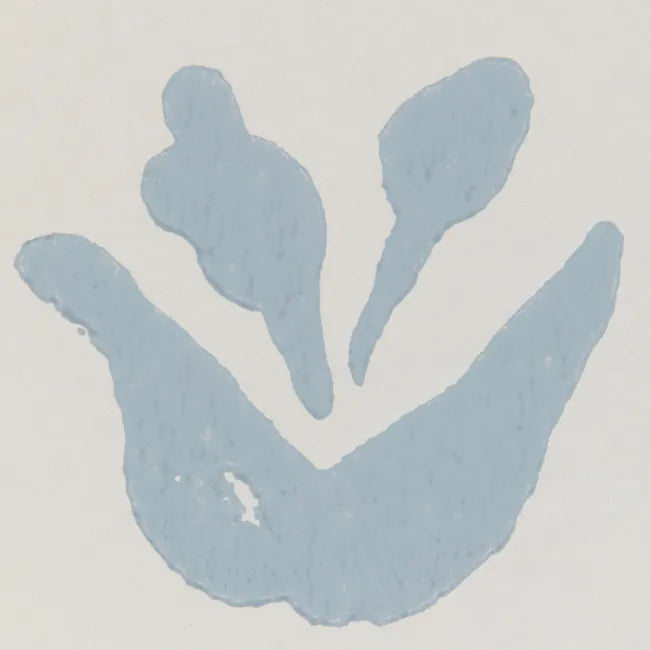Close up Blue leaf-like shapes on light wallpaper 