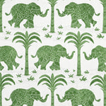 Pattern of green elephants and trees on a white fabric 