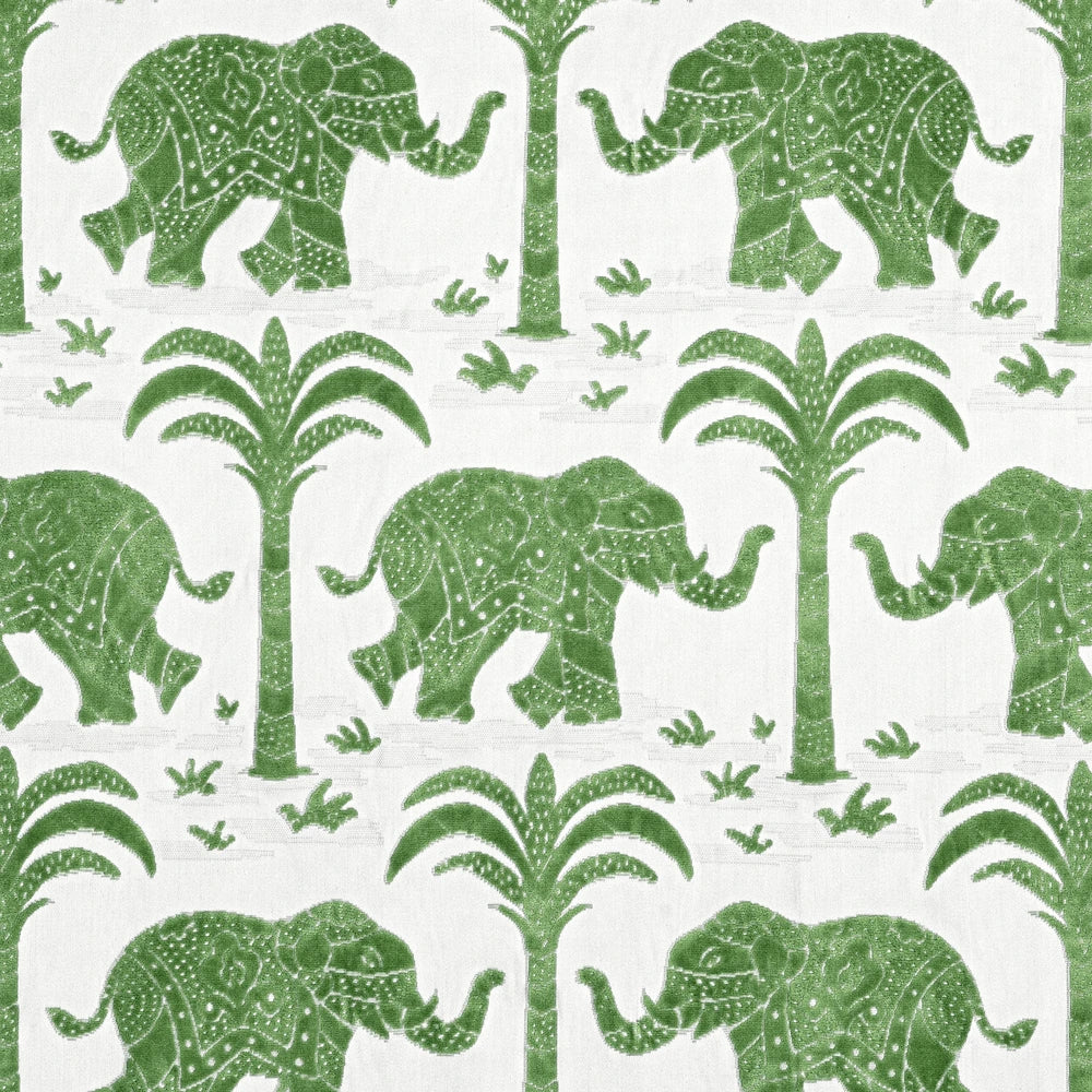 Pattern of green elephants and trees on a white fabric 