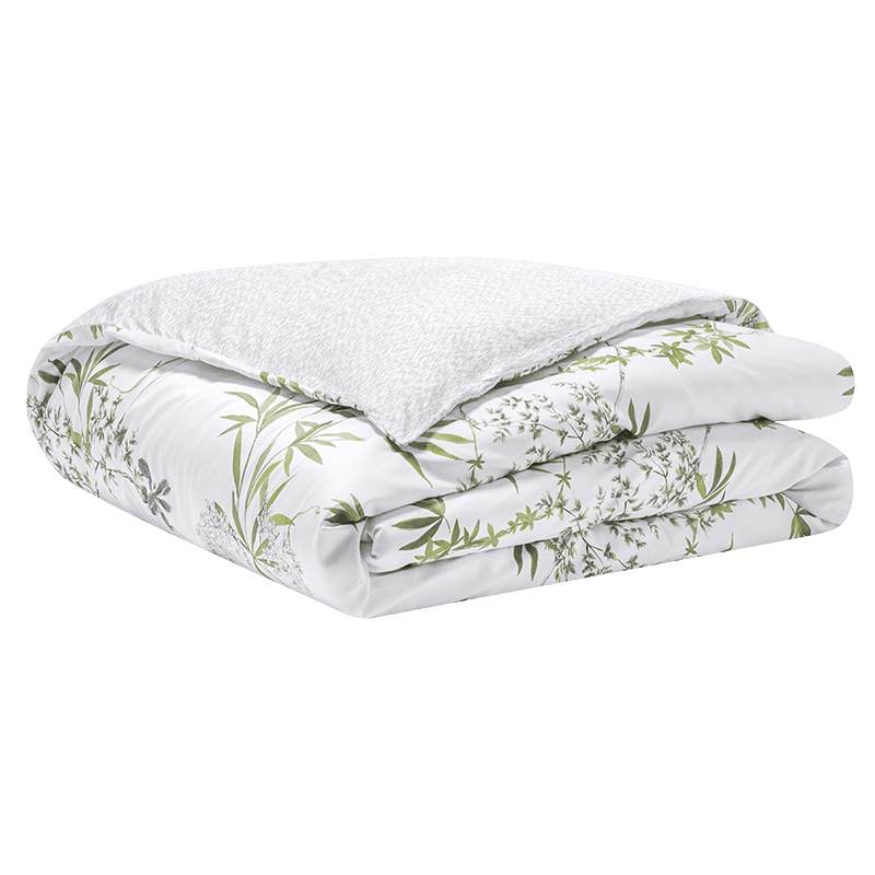 Folded white comforter with green floral pattern on a transparent background