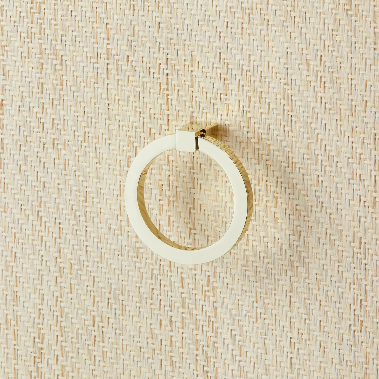 close up of raffia wrapped side table brass knob 