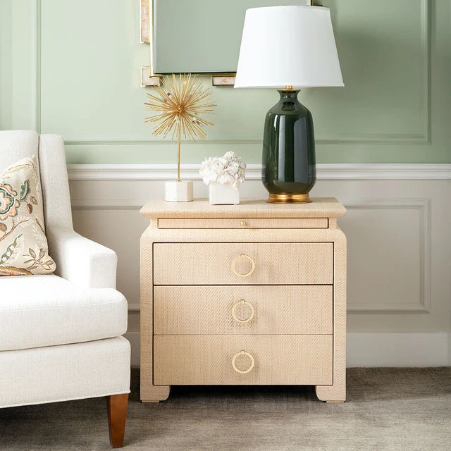raffia wrapped side table against a wall and next to a white side chair 